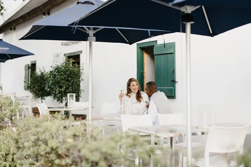 Couple enjoying drinks at an outdoor cafe, perfect for restaurant bookings
