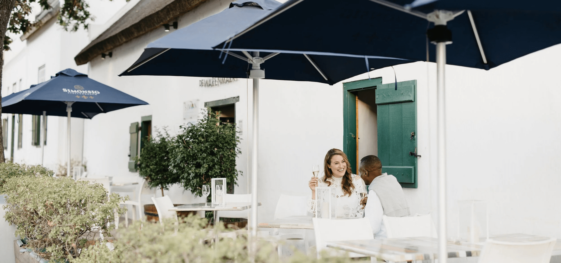 Couple enjoying wine on a patio at Simonsig Wine Estate