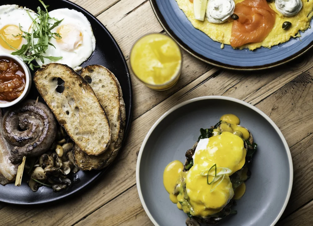 Assortment of delicious brunch dishes including eggs benedict, full English breakfast, and smoked salmon omelet.