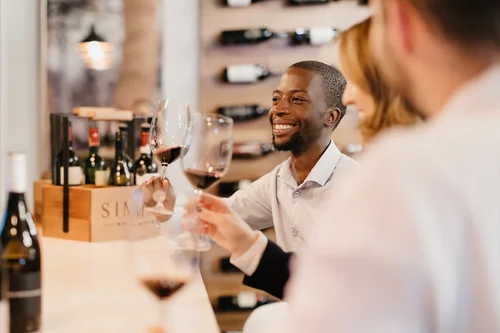 Friends enjoying wine tasting after booking an experience.
