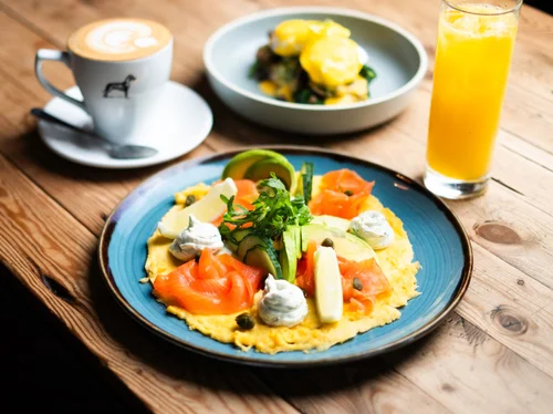Smoked salmon omelet with avocado and capers, coffee, and orange juice