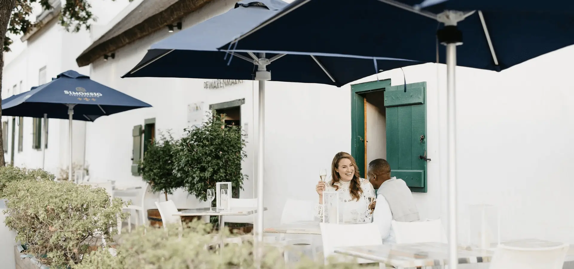 Couple enjoying wine on a patio at Simonsig Wine Estate